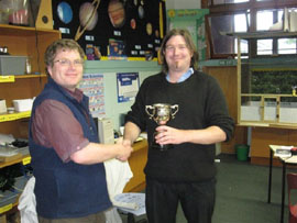 Club Captain Stewart Holdaway presents Mathew King with the Championship trophy